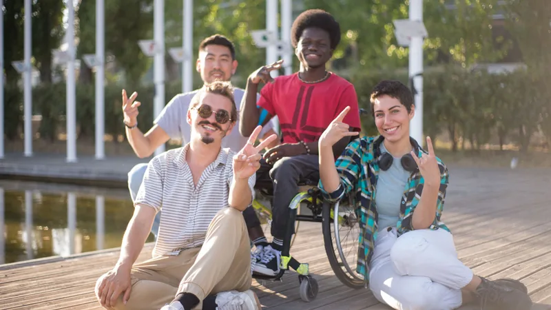 Friends spending time outdoors together, including a wheelchair user.