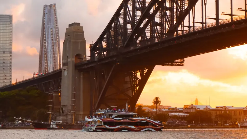 Sydney Harbour Bridge and the waterfront at sunset.